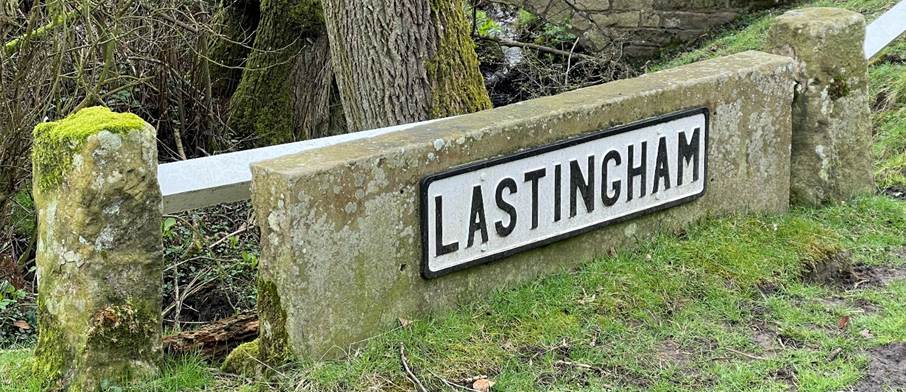 A sign on a stone wall
Description automatically generated